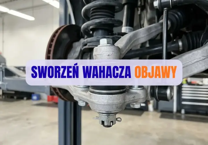 Widok na element zawieszenia samochodu, gdzie widoczny jest sworzeń wahacza. Objawy jego zużycia mogą być niepokojące.