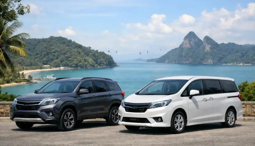 Szary SUV i biały minivan na tle tropikalnej zatoki z górami i kolejką linową.