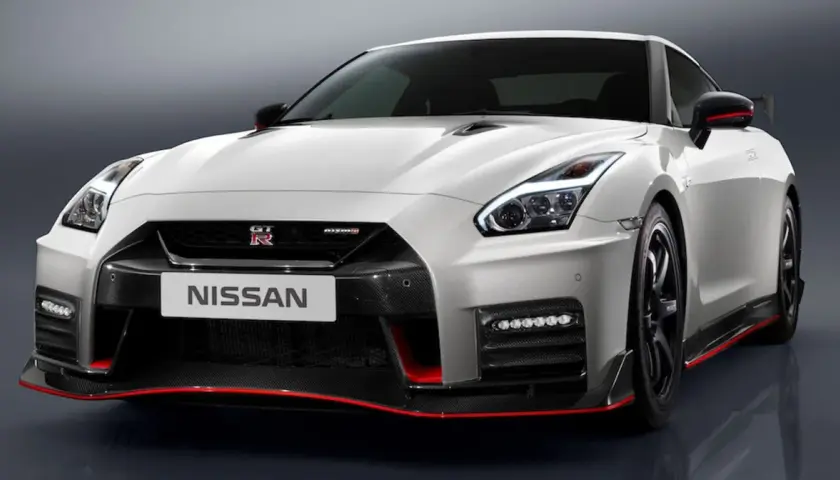 Biały Nissan GT-R Nismo z czerwonymi akcentami, prezentujący sportowy design i agresywną sylwetkę.