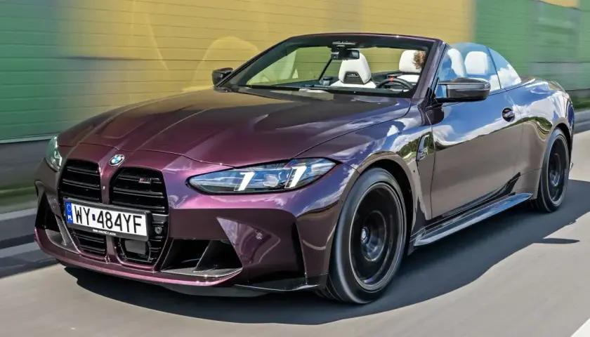 Fioletowe BMW M4 kabriolet w ruchu. Sprawdź aktualną bmw m4 cena i poczuj wolność jazdy.